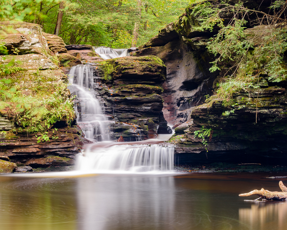 Water flowing over an eroded shelf creates a small waterfall.