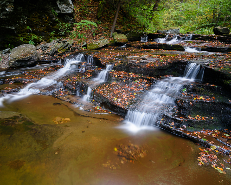 Water cascades over a shale steps.