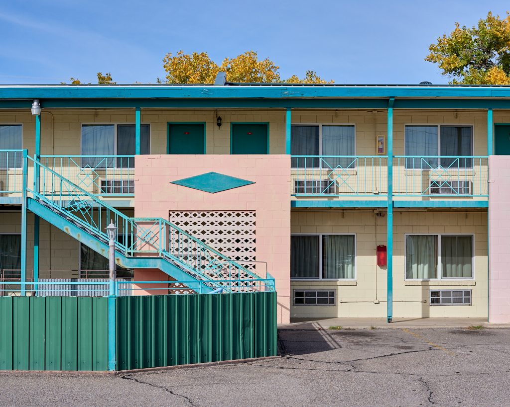 A hotel painted pink and green.