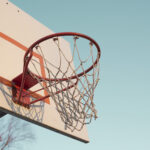 Color photo of a basketball hoop and net.