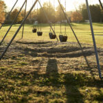 Color photo of a swings in the afternoon.