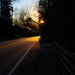 Color photograph of the sun reflecting off the asphalt late afternoon winter.