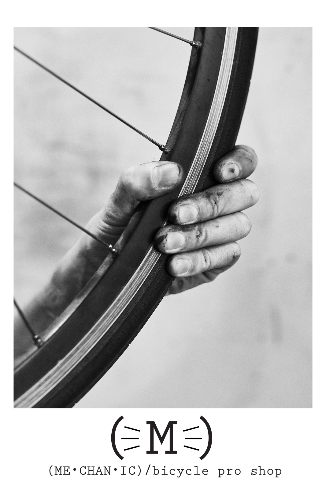 Picture of a greasy hand holding onto a bicycle wheel.