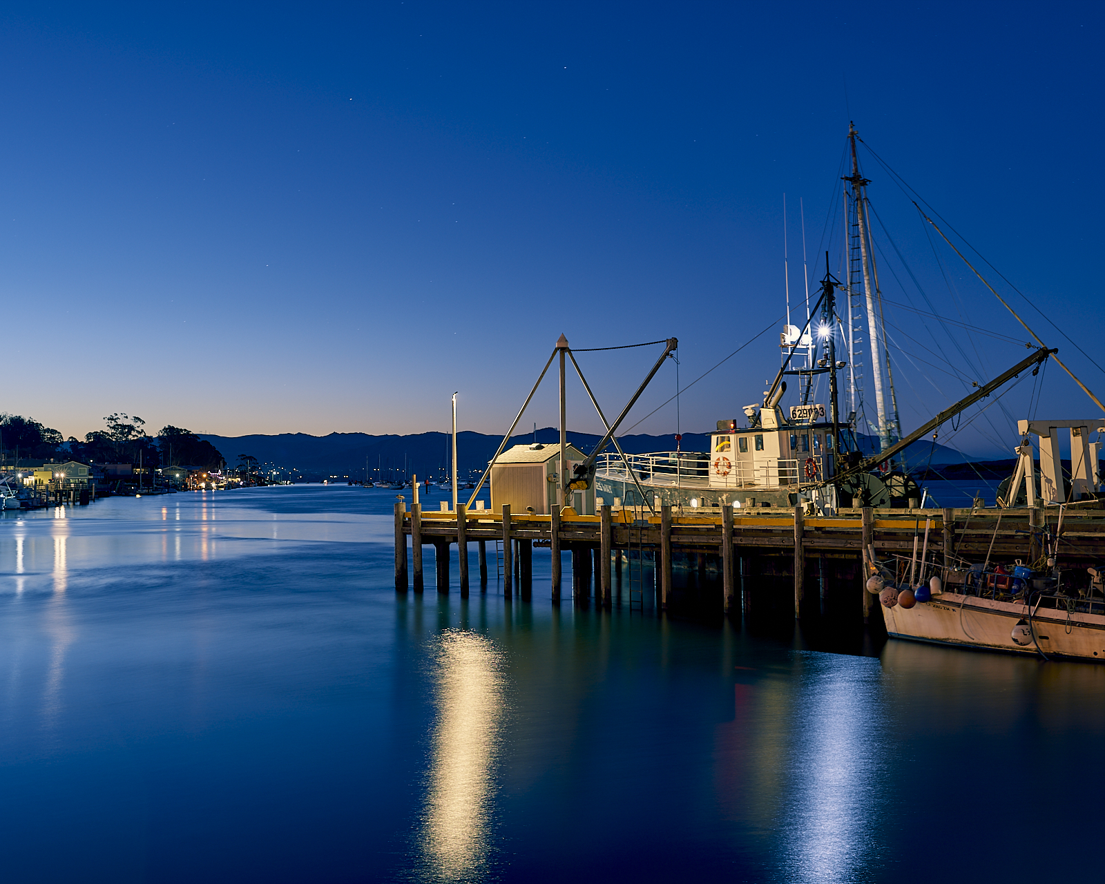 Urban #181230.2. A photograph of a boat docked in the predawn gloom.