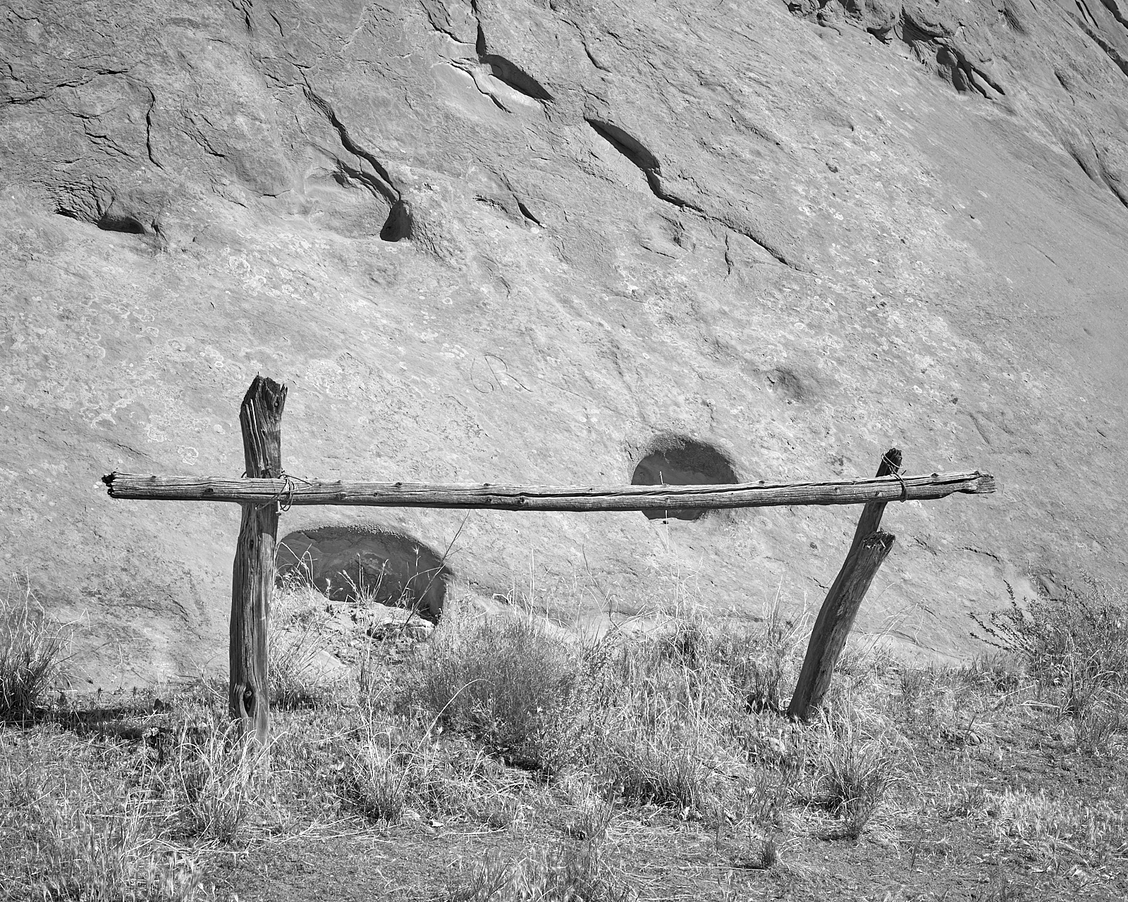 Landscape #200513. A black and white photograph of old corral posts and weeds.