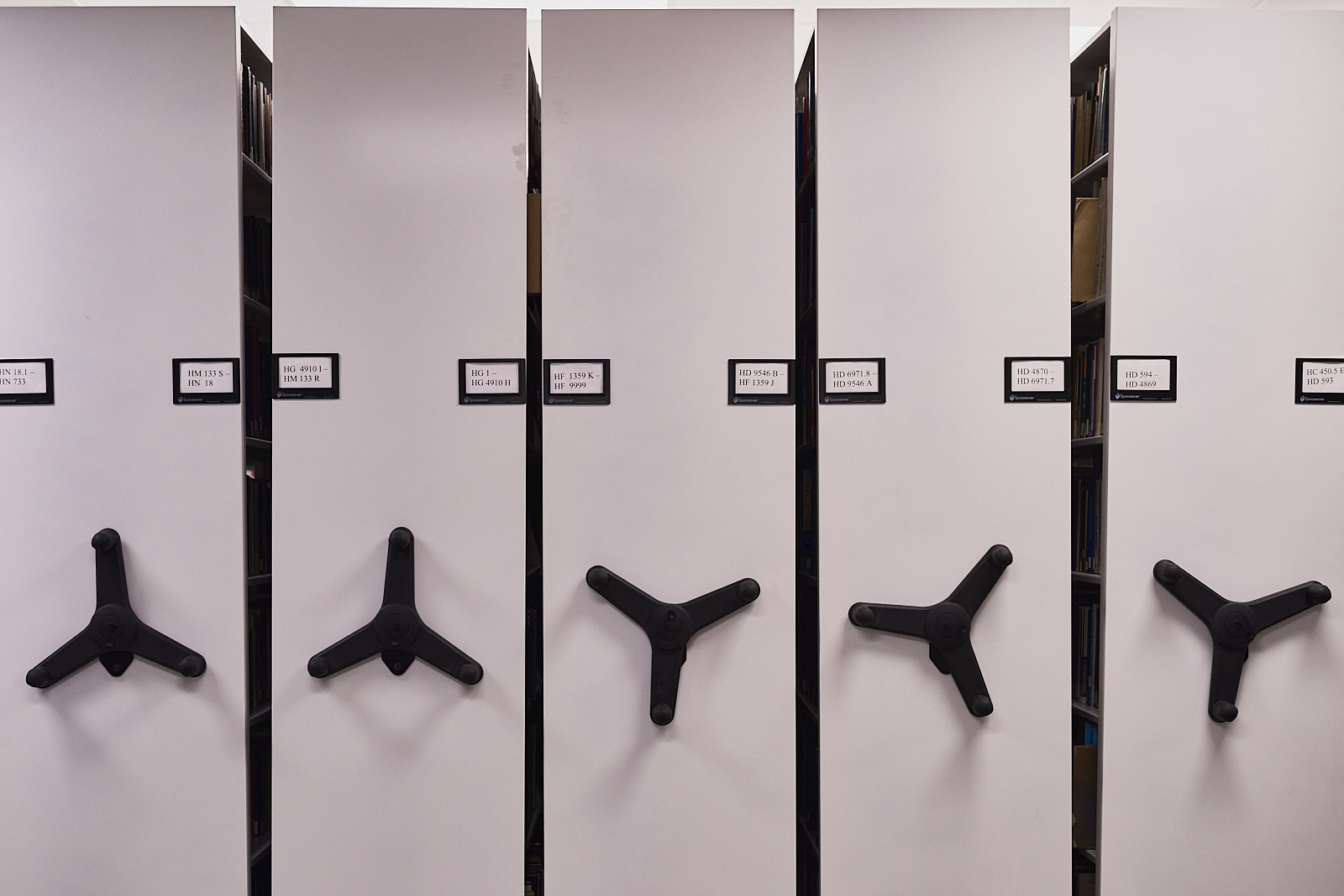 Urban #220107: Color photograph of compact shelving in a library.