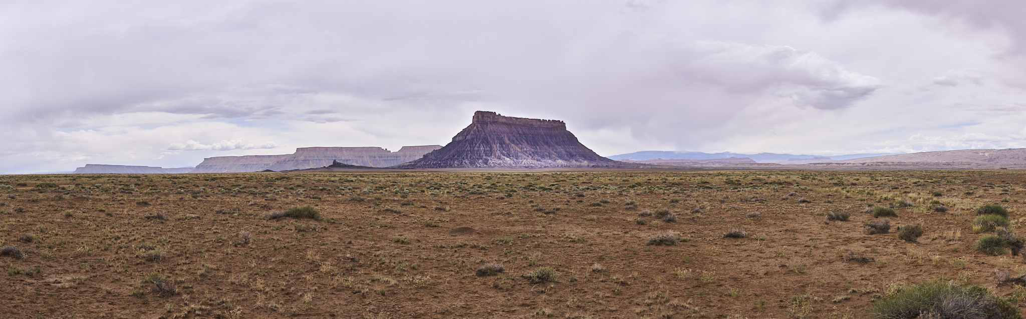 Landscape #230612. A color photograph of a butte against a cloudy sky.