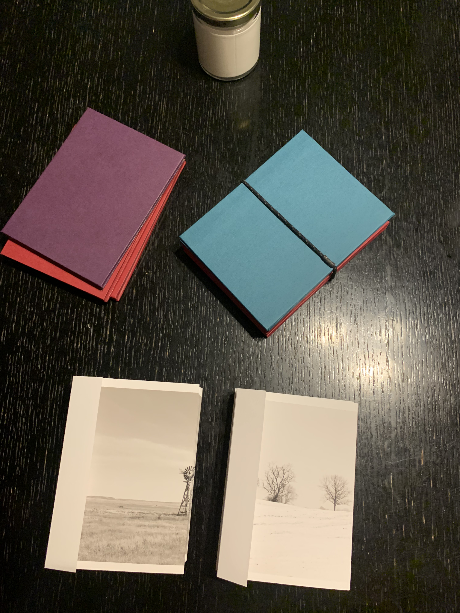 Color photo of some hand-made books on a table.