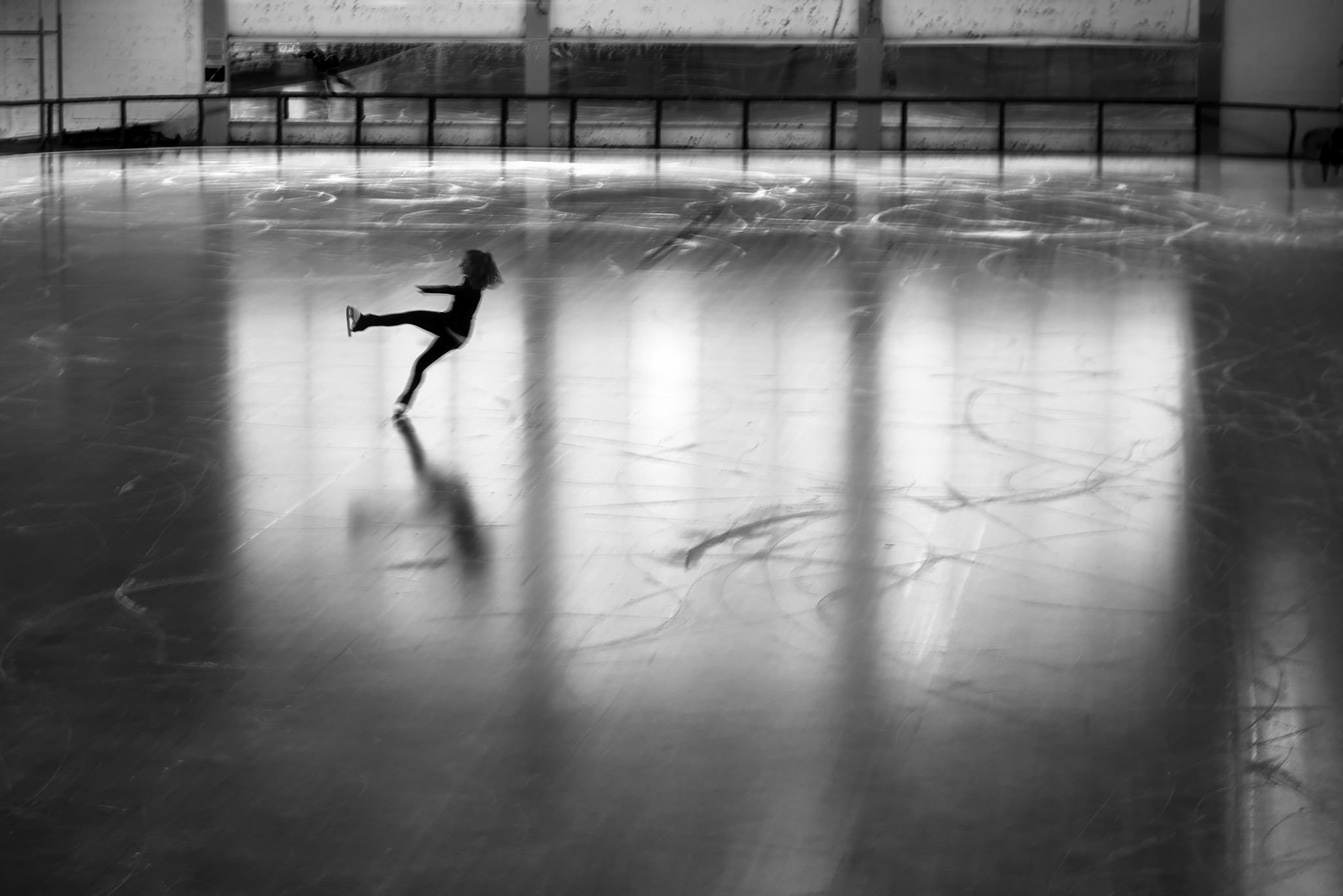 Urban #230717. A black and white photograph of a person ice skating alone.