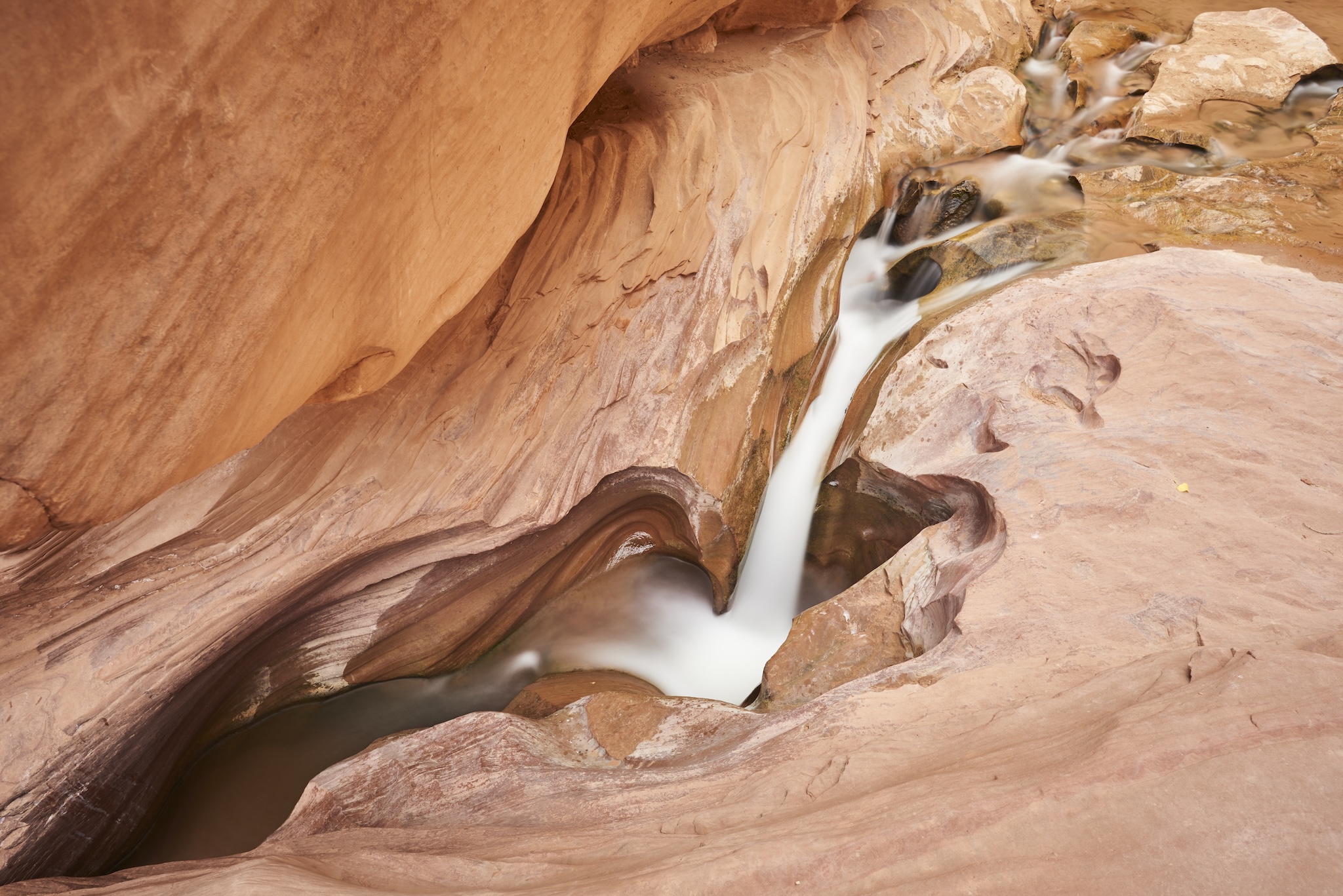 Landscape #230615. A color photograph of water flowing through a narrow channel.