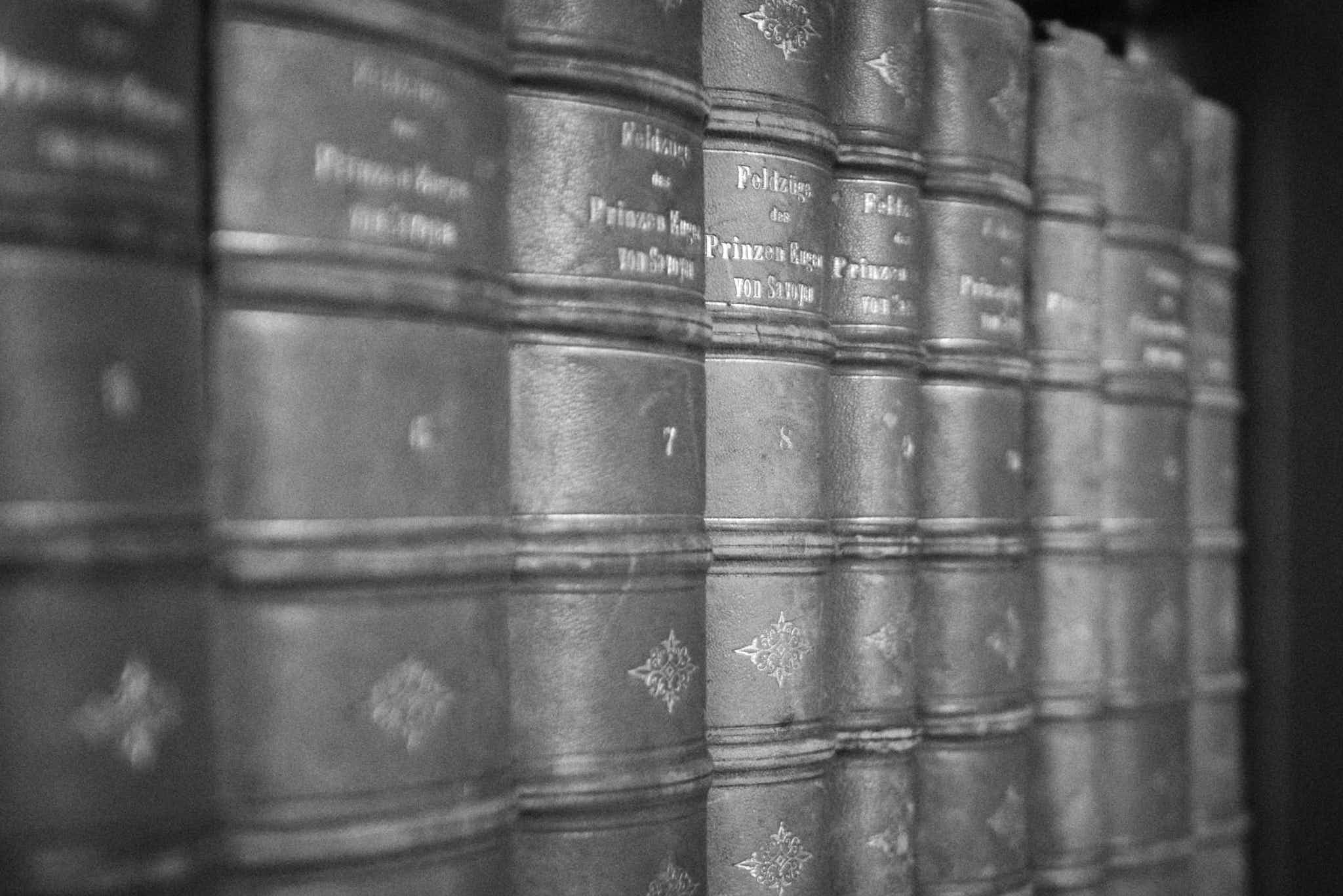 Still life #240331.1. A black and white photograph of old books on a shelf.