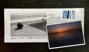 A color photo of two homemade postcards, lying on a table.